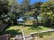Lush backyard with mature trees and patio, perfect for outdoor gatherings and relaxation at 2154 Lake Christie Dr, Orlando, FL 32809