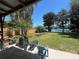 Serene backyard with a covered patio, garden area, and stunning lake views, ideal for relaxation and entertainment at 2154 Lake Christie Dr, Orlando, FL 32809