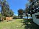 Spacious backyard offering a peaceful retreat with mature trees and view of the lake at 2154 Lake Christie Dr, Orlando, FL 32809