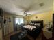 Spacious bedroom with hardwood floors, a bed, and a window with curtains at 2154 Lake Christie Dr, Orlando, FL 32809