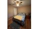 Cozy bedroom featuring a comfortable bed, hardwood flooring, and a ceiling fan at 2154 Lake Christie Dr, Orlando, FL 32809