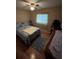 Comfortable bedroom with wood floors, a ceiling fan, nightstand, and natural lighting at 2154 Lake Christie Dr, Orlando, FL 32809