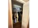 Organized closet with clothes hanging on rods and shelves for storage at 2154 Lake Christie Dr, Orlando, FL 32809