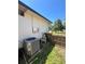 Side view of an air conditioning unit and fenced yard with a corner view of the neighborhood at 2154 Lake Christie Dr, Orlando, FL 32809