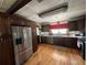 Spacious kitchen featuring stainless steel fridge, tile ceiling, and hardwood floors at 2154 Lake Christie Dr, Orlando, FL 32809