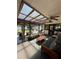 Cozy sunroom with ceiling fan, skylight, comfortable furniture, and peaceful outdoor views at 2154 Lake Christie Dr, Orlando, FL 32809