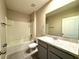 Bathroom featuring a tub and shower combination and a single sink vanity at 216 Grove Branch Rd, Winter Haven, FL 33880