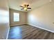 Bedroom featuring wood-look floors, a ceiling fan, and natural light from window at 216 Grove Branch Rd, Winter Haven, FL 33880
