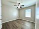Bedroom featuring wood-look floors, ceiling fan, and natural light from window at 216 Grove Branch Rd, Winter Haven, FL 33880