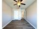 Bedroom showcasing wood-look floors, ceiling fan, and doorways to closet and hall at 216 Grove Branch Rd, Winter Haven, FL 33880