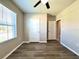 Bedroom with wood-look floors and doorways to closet and hall at 216 Grove Branch Rd, Winter Haven, FL 33880