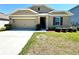 Charming single-story home with a well-manicured lawn and a neutral-colored exterior at 216 Grove Branch Rd, Winter Haven, FL 33880