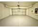 Garage featuring an open garage door and epoxy flooring at 216 Grove Branch Rd, Winter Haven, FL 33880