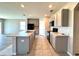 Bright kitchen featuring an island with a sink, sleek black appliances, and neutral-tone cabinetry at 216 Grove Branch Rd, Winter Haven, FL 33880