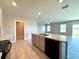 Kitchen area with a large island with a sink, cabinets and views of the living space at 216 Grove Branch Rd, Winter Haven, FL 33880
