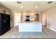 Kitchen showcasing a large island, modern appliances, neutral cabinets, and easy access to other rooms at 216 Grove Branch Rd, Winter Haven, FL 33880