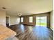 Inviting living room area with a ceiling fan, bright windows, sliding glass doors and wood-look flooring at 216 Grove Branch Rd, Winter Haven, FL 33880