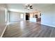 Expansive living area with wood-look flooring, ceiling fan, natural light and a view into the kitchen at 216 Grove Branch Rd, Winter Haven, FL 33880
