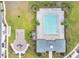 Aerial view of community pool and playground area with lounge chairs, mature trees, and landscaping at 2731 Rowan St, Tavares, FL 32778