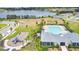 Aerial view of the community pool, playground, and clubhouse near a tranquil lake with lush landscaping at 2731 Rowan St, Tavares, FL 32778