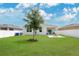 Well maintained backyard features a fire pit and lush lawn at 2731 Rowan St, Tavares, FL 32778