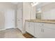 Bathroom featuring double sinks with granite countertops, white cabinetry, and tile flooring at 2731 Rowan St, Tavares, FL 32778
