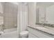 Bright bathroom features granite countertops, large mirror and shower with white curtain at 2731 Rowan St, Tavares, FL 32778