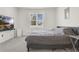 Bedroom with soft gray carpet, a queen-sized bed, flatscreen TV and a bright window with exterior view at 2731 Rowan St, Tavares, FL 32778