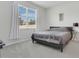 Bedroom with soft gray carpet, a queen-sized bed, and a bright window with exterior view at 2731 Rowan St, Tavares, FL 32778