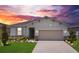 Charming single-story home with a two-car garage and a beautifully landscaped front yard, enhanced by lawn lighting at 2731 Rowan St, Tavares, FL 32778