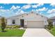 Charming single-story home with a two-car garage and a beautifully landscaped front yard, enhanced by lawn lighting at 2731 Rowan St, Tavares, FL 32778