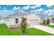 Beautifully landscaped single-story home featuring a two-car garage and well-maintained lawn at 2731 Rowan St, Tavares, FL 32778