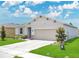 Single-story home featuring a two-car garage and well-maintained lawn at 2731 Rowan St, Tavares, FL 32778