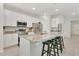 Bright kitchen with white cabinets, stainless steel appliances, granite countertops, and a large island with seating at 2731 Rowan St, Tavares, FL 32778