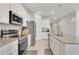 Modern kitchen featuring stainless steel appliances, granite countertops, and bright white cabinets at 2731 Rowan St, Tavares, FL 32778