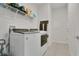 Laundry room with tile flooring, washer and dryer and overhead shelving at 2731 Rowan St, Tavares, FL 32778