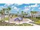 Community playground features a slide, other playground equipment and lush landscaping and trees at 2731 Rowan St, Tavares, FL 32778