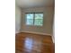 Cozy bedroom with hardwood floors and a window offering natural light at 275 Virginia Dr, Winter Garden, FL 34787