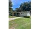 Well-maintained single-story house features a green lawn, and a walkway leading to the charming front entrance at 275 Virginia Dr, Winter Garden, FL 34787