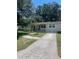 Charming single-story home with a concrete driveway, lush landscaping, and a welcoming front porch at 275 Virginia Dr, Winter Garden, FL 34787