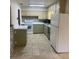 Functional kitchen with tile flooring, a range, ample cabinetry, and essential appliances at 275 Virginia Dr, Winter Garden, FL 34787
