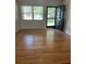 Inviting living room featuring hardwood floors, a bright window, and a stylish front door with glass panels at 275 Virginia Dr, Winter Garden, FL 34787