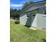 Rear entrance of a single-story home with a well-maintained lawn and a white door at 275 Virginia Dr, Winter Garden, FL 34787