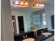 Bathroom mirror reflects double sinks, garden tub, and glass shower for a spa-like oasis at 2753 Monticello Way, Kissimmee, FL 34741