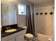Clean bathroom with tub and shower combination, granite countertops, and tiled walls with a window at 2753 Monticello Way, Kissimmee, FL 34741