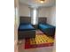 Cozy bedroom with two twin beds, wood frames, and a colorful alphabet rug on carpet at 2753 Monticello Way, Kissimmee, FL 34741