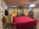 Bedroom features patterned wallpaper, decorative lamps, and wood-look flooring at 2753 Monticello Way, Kissimmee, FL 34741