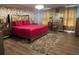 Inviting bedroom featuring wood floors, soft lighting, and a decorative wall design and area rug at 2753 Monticello Way, Kissimmee, FL 34741