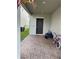 Covered front entrance with a brick-paved walkway, modern door, and bikes at 2753 Monticello Way, Kissimmee, FL 34741