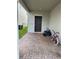 Covered front entrance with a brick-paved walkway, modern door, and bikes at 2753 Monticello Way, Kissimmee, FL 34741
